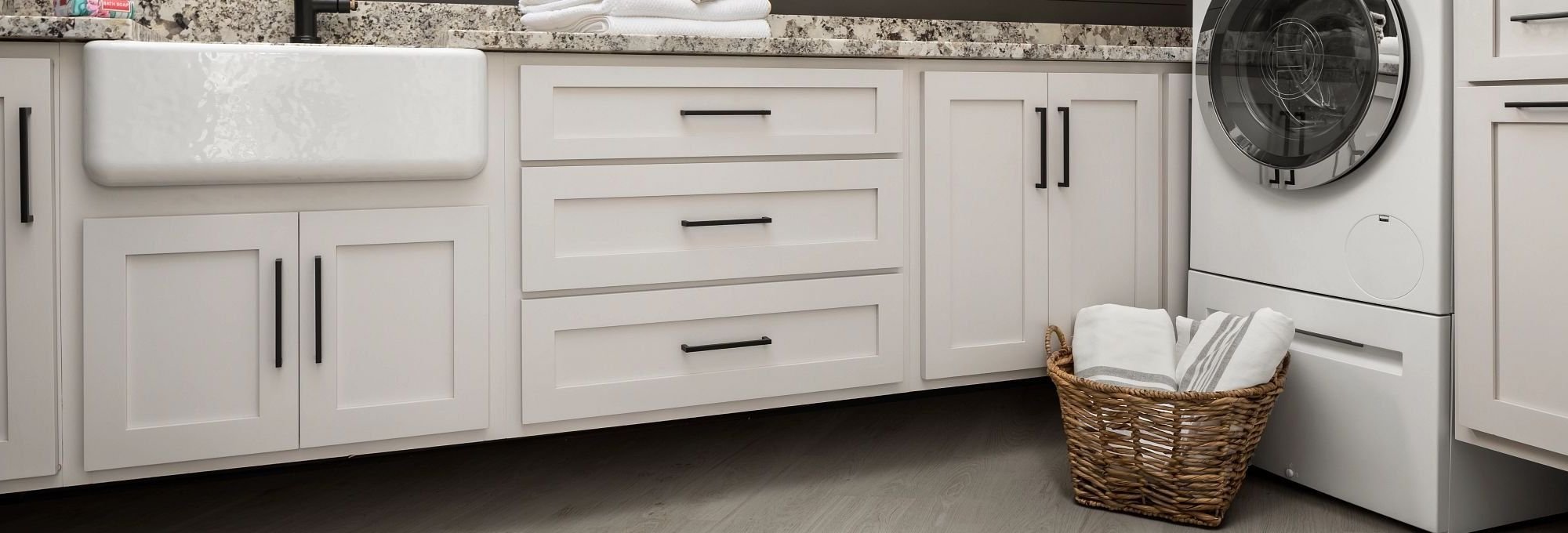 Kitchen with laundry basket on wood-look luxury vinyl flooring from 180 Degree Floors in the Nashville, TN area