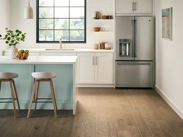 large modern kitchen with white bar top and bar stools from 180 Degree Floors in the Nashville, TN area